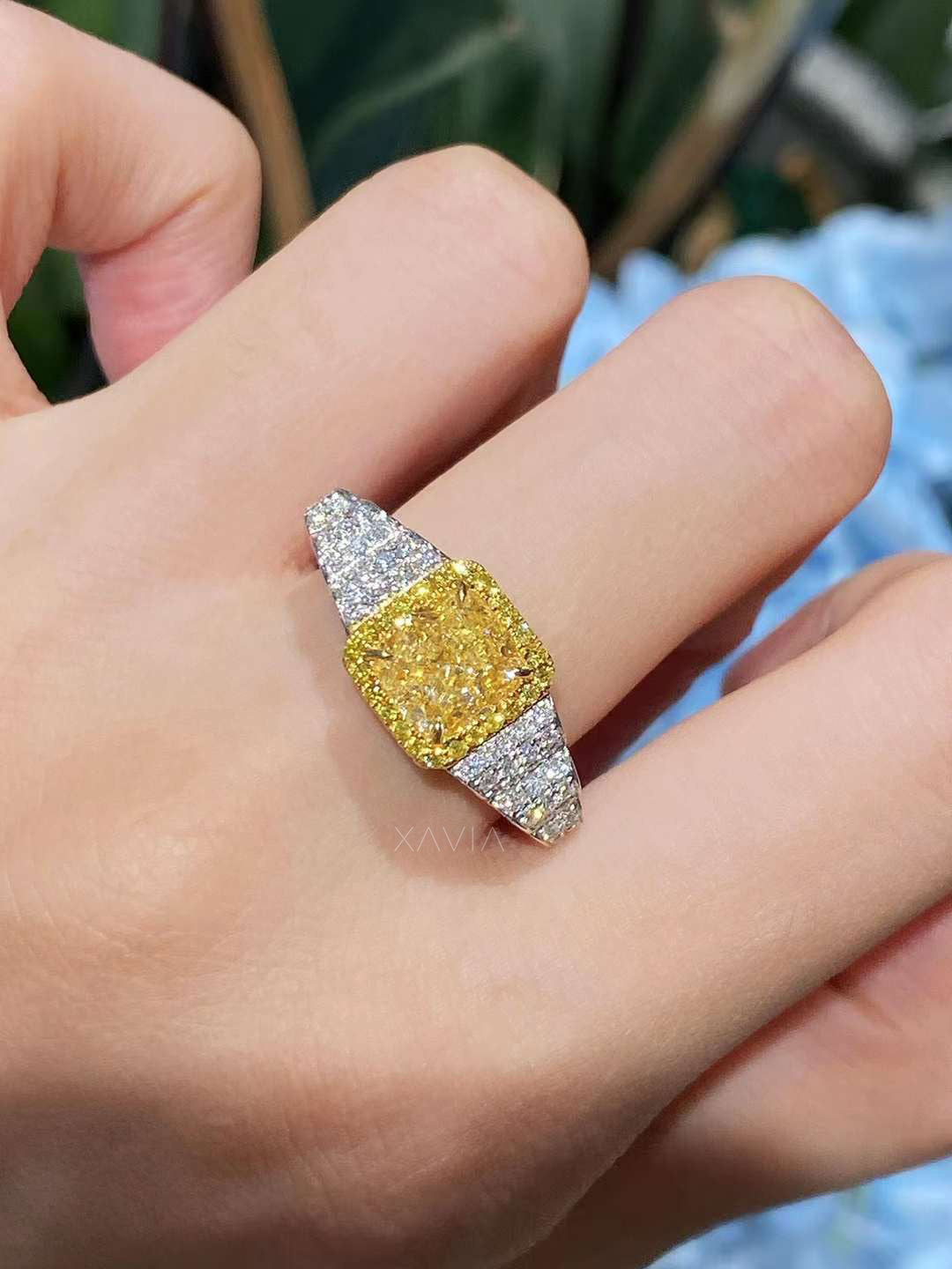 Zeyora fancy yellow cushion cut diamond ring with pavé white diamonds, shown on hand sparkling under natural daylight